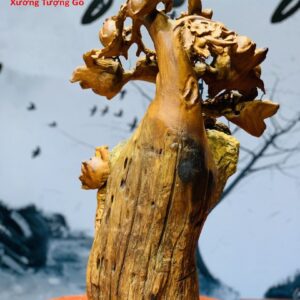 Di Lặc Gánh Gậy Đứng cây Đào