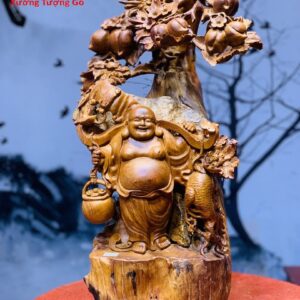 Di Lặc Gánh Gậy Đứng cây Đào
