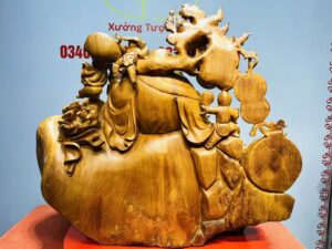 Di Lạc Cửu Tiểu vác cành đào ngồi bao tiền Gỗ Nu Hương
