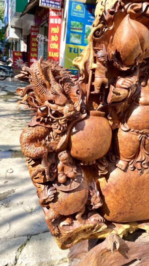 Di Lạc Ngũ Phúc Tứ Linh Vác Cành Đào Đứng Bao Tiền Gỗ Nu Hương